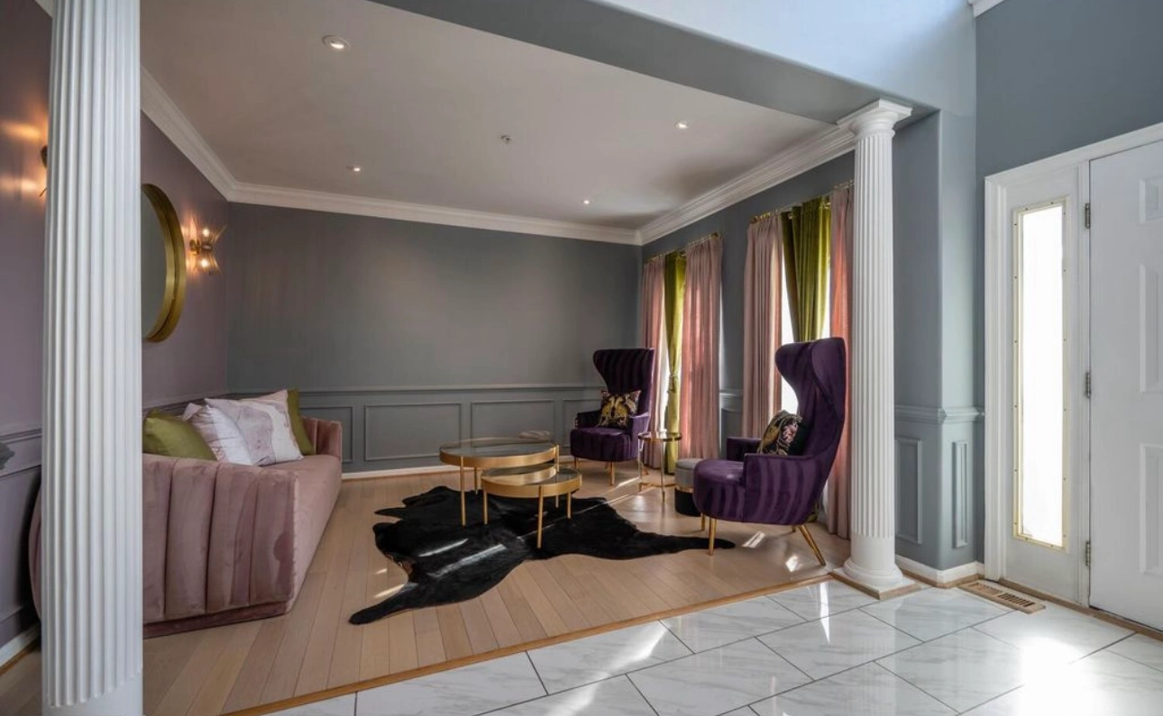 living room professionaly painted by CV painting. white pillars, dark pink walls and grey accents.