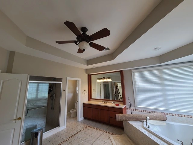 bathroom of a rockville Maryland home with walls, celings, and trim painted beige amd white.