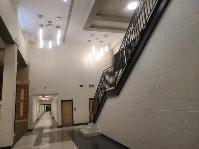 Gaithersburg middle school stairwell painted white and metal railing restained black.