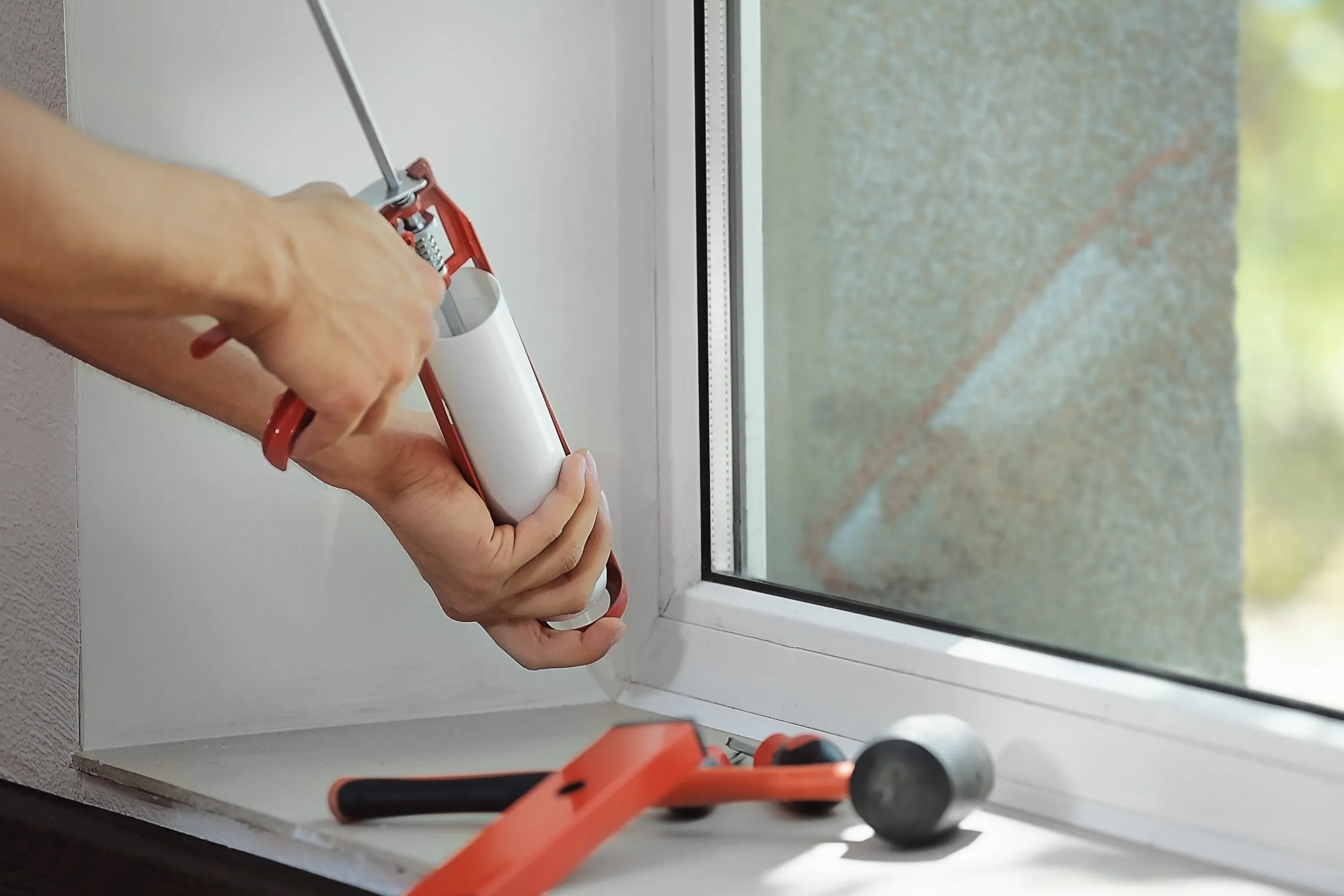 ceiling a window by using caulk.